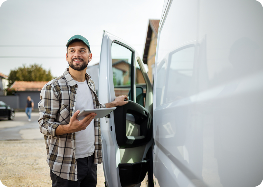 Man holding tablet by a van